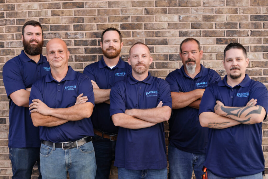 Faszold team photo of men in uniforms with arms crossed